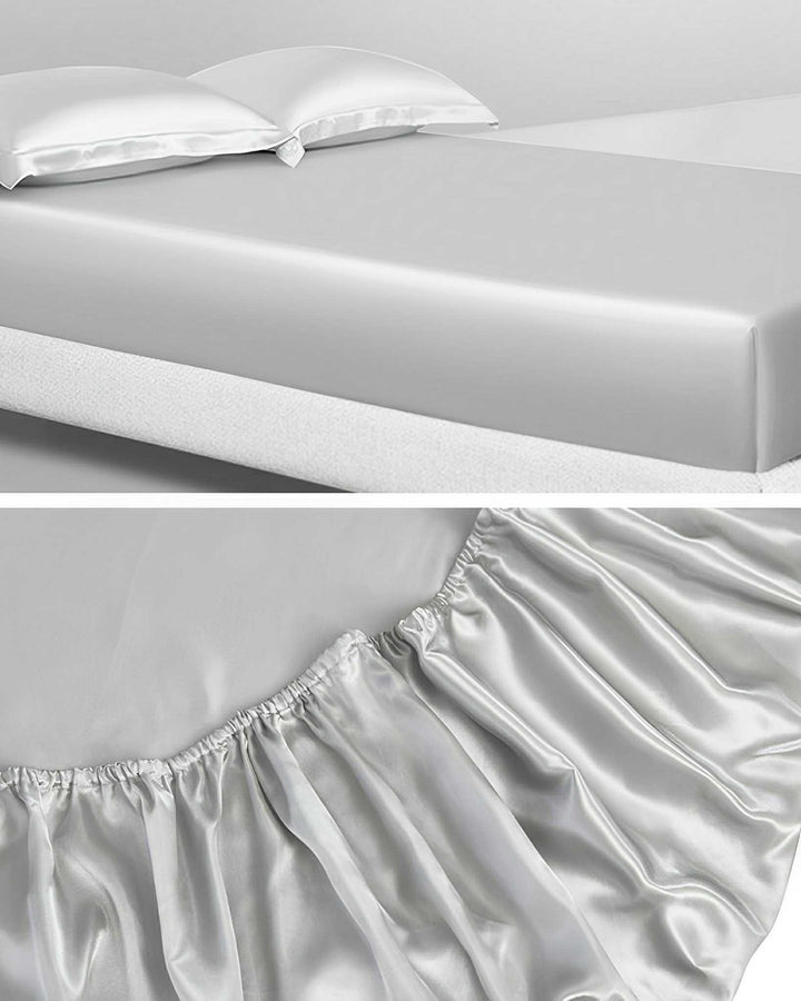 A bed featuring a 19 Momme Seamless Silk Fitted Sheet by SusanSilk with two matching pillowcases; close-up of the fitted sheet's elastic edge showcasing its seamless fit reminiscent of the smoothness found in SusanSilk.