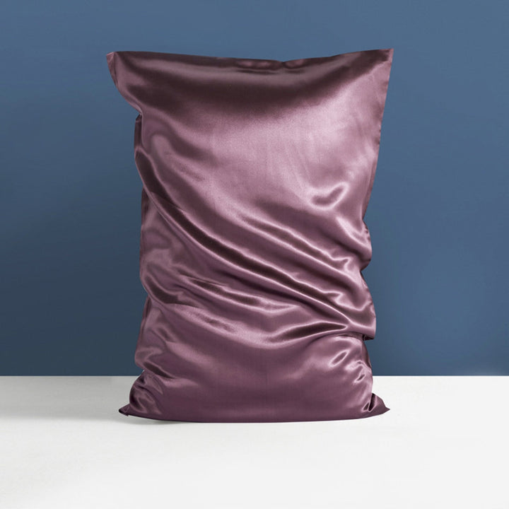 22 Momme High Gloss Silk Pillowcase Envelope by SusanSilk, in a rich purple satin, on a white surface with a blue background.