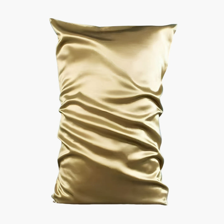 A 22 Momme High Gloss Silk Pillowcase Envelope from SusanSilk, tightly wrapped in gold satin with visible creases and folds. Made from luxurious silk, the material appears smooth and shiny.