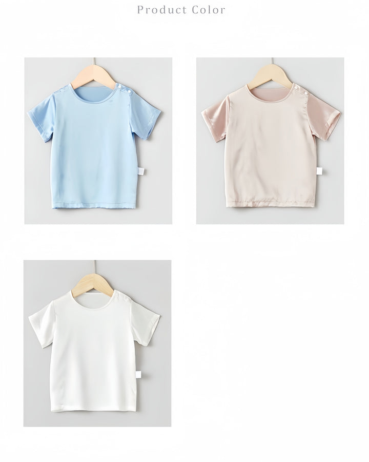 Three 19 Momme Baby & Toddler Silk Short Sleeve Tops by SusanSilk on hangers. Top left: light blue, top right: light beige, bottom center: white. These luxurious tops feel like a baby's second skin.