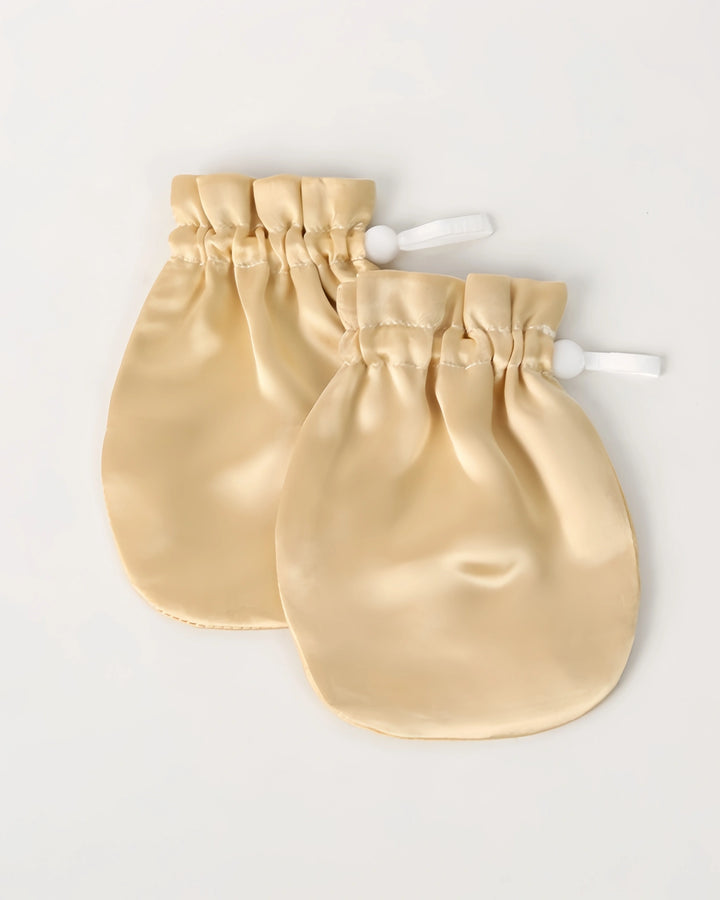 Lavender-toned 19 momme baby silk gloves that help reduce face grabbing and promote calm sleep with breathable natural silk fabric.
