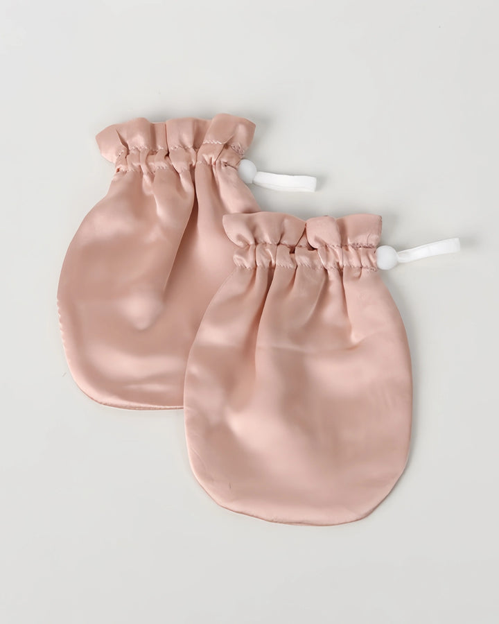 Single pair of 19 momme baby silk gloves laid flat on a light background, showcasing anti-face grabbing design for everyday baby care.