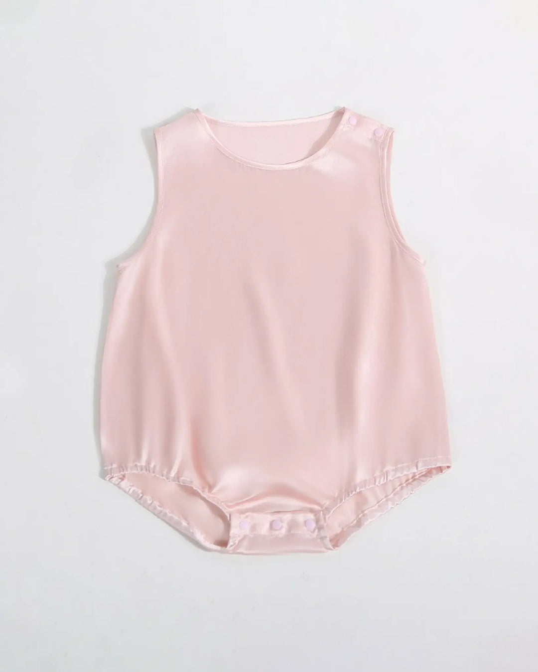The 19 Momme Silk Baby Button Onesie by SusanSilk is a pale pink baby romper made from soft silk, featuring snap closures at the shoulder and bottom