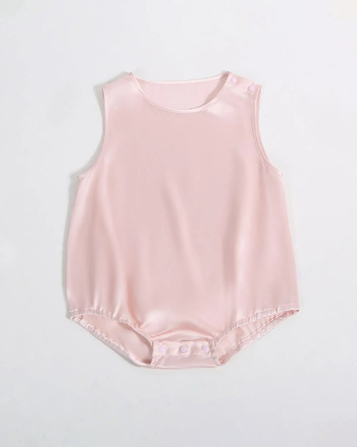 The 19 Momme Silk Baby Button Onesie by SusanSilk is a pale pink baby romper made from soft silk, featuring snap closures at the shoulder and bottom
