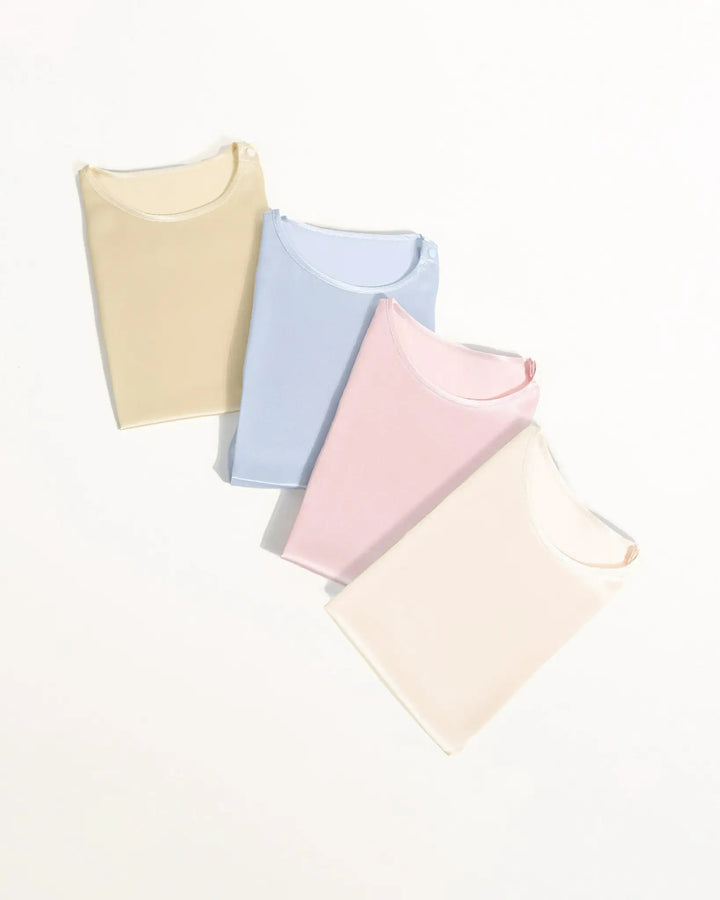 Four pastel-colored baby blankets stacked on a white background.19 Momme Mulberry Silk Baby Button Onesie 