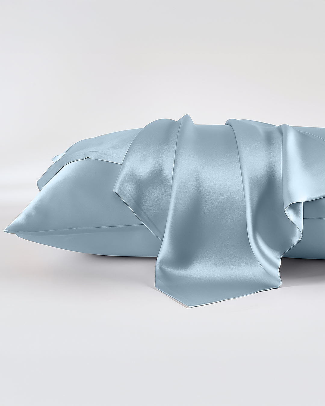 Light blue satin pillowcase on a white background