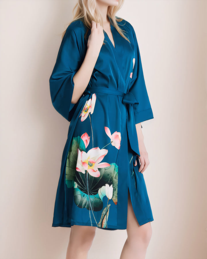 A person wearing the "Lotus Style Short Silk Kimono" by SusanSilk, holding the collar and standing against a plain background.