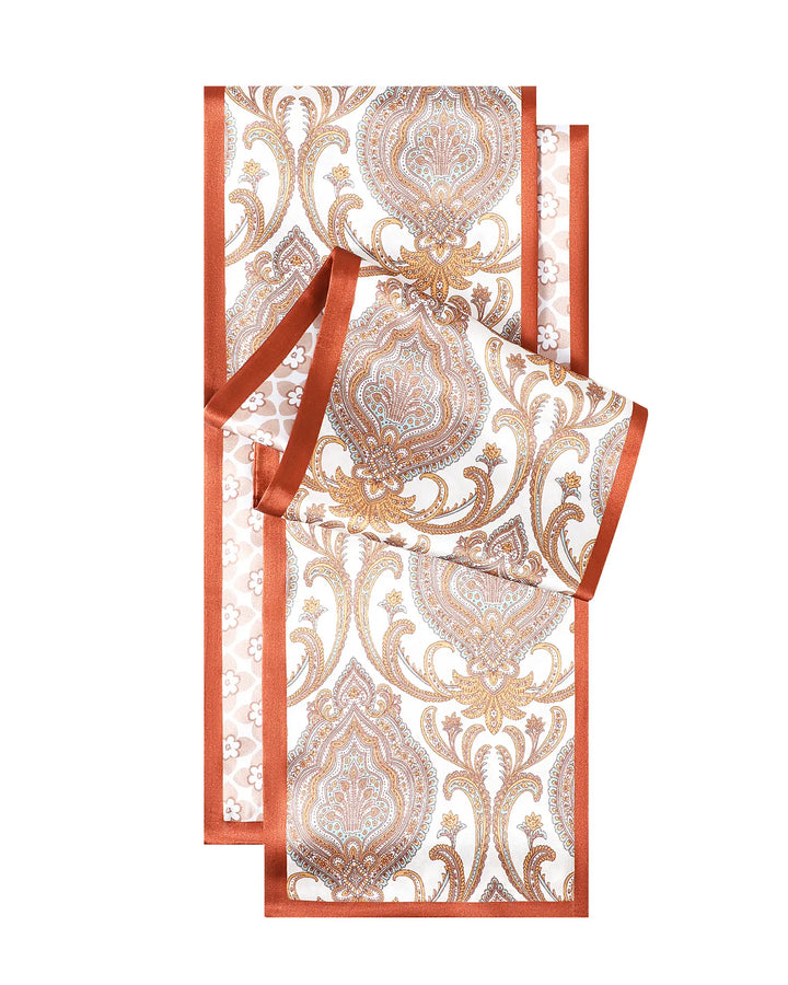 Decorative box with gold and white pattern and a red ribbon on a white background