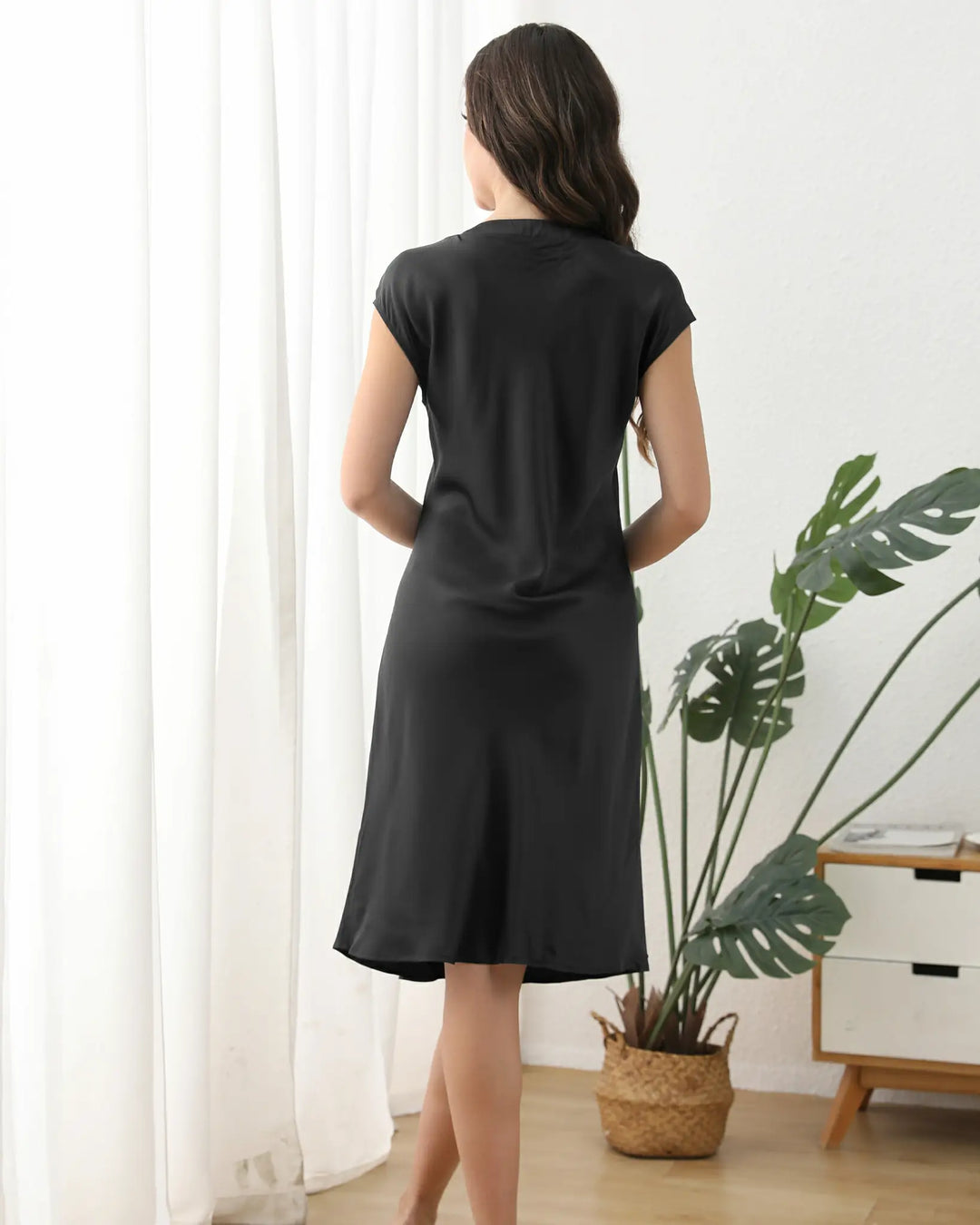 The V-neckline and cap sleeves frame your features delicately, while the loose, relaxed fit ensures unrestricted movement—perfect for lounging, dressing up, or even casual daytime wear.#color_black