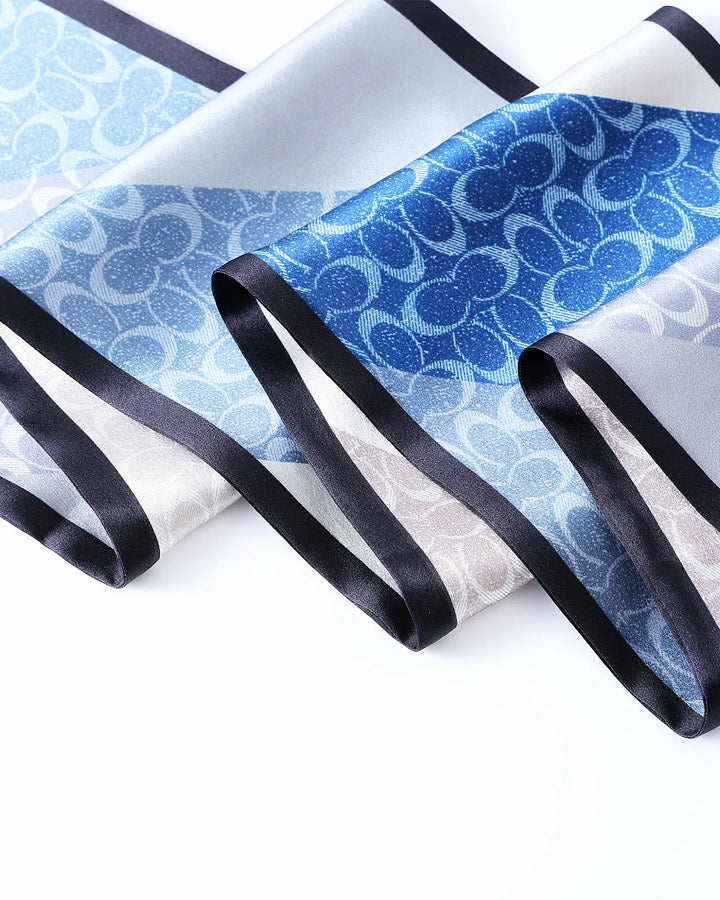 Blue and white patterned fabric with black ribbons on a white background