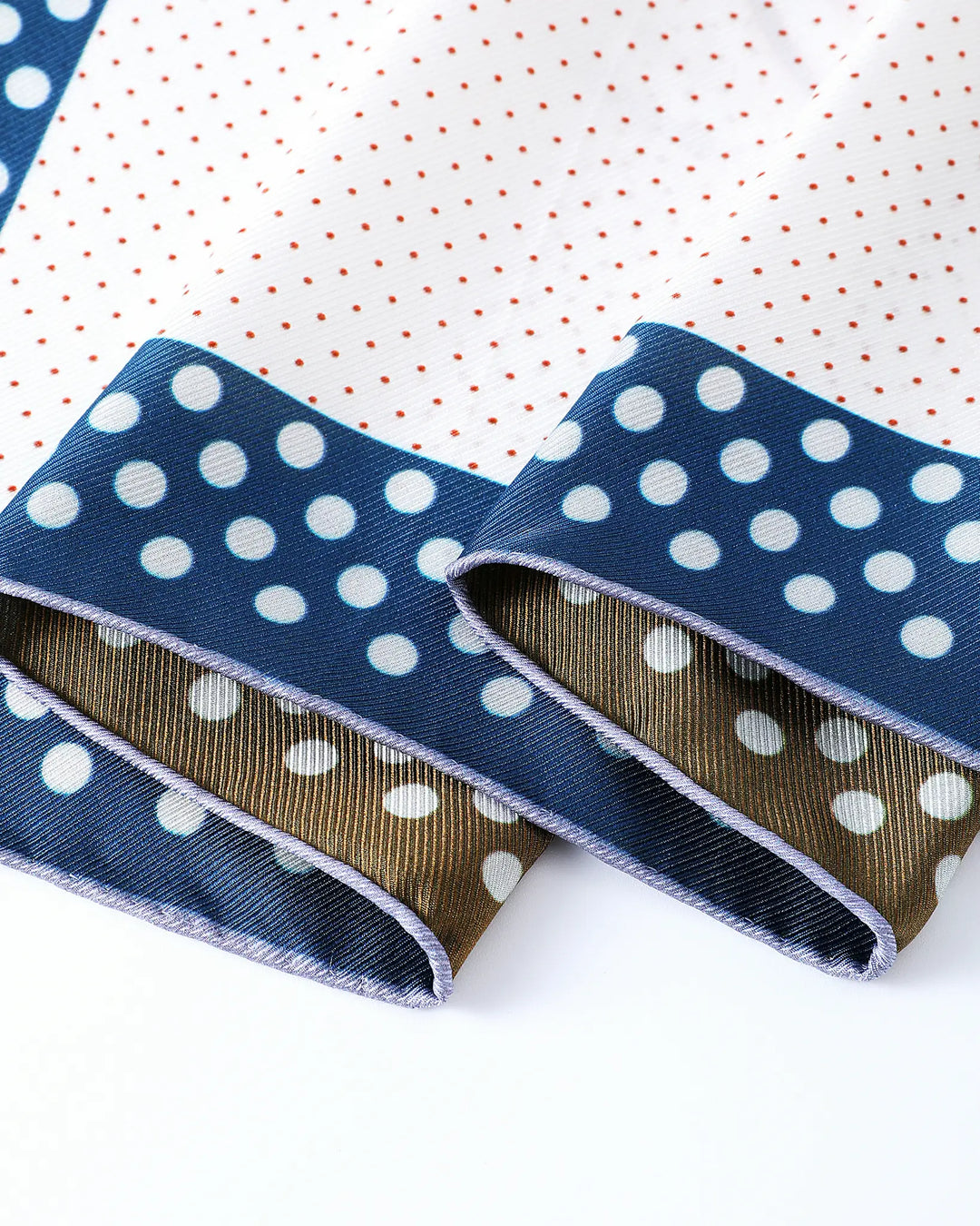 Two blue ribbons with white polka dots on a white background
