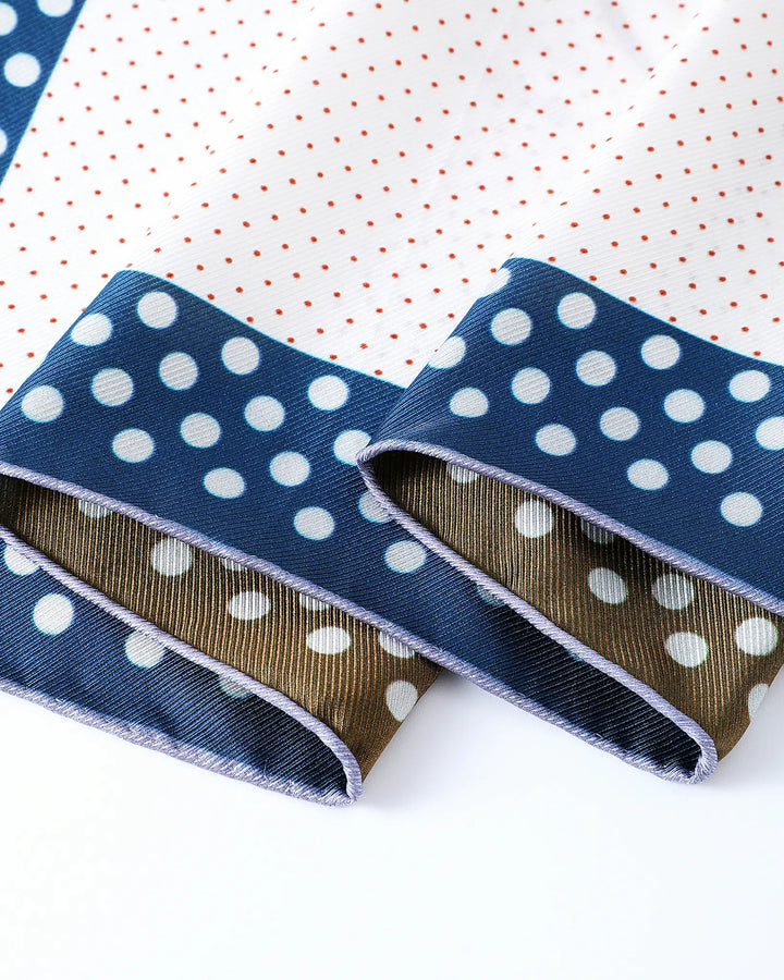 Two blue ribbons with white polka dots on a white background