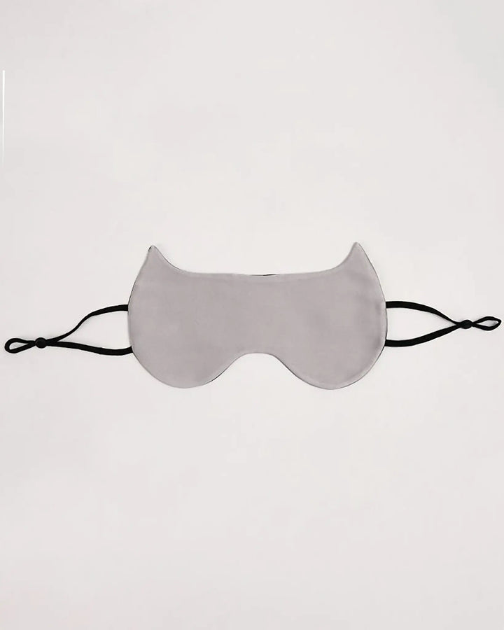 A Cat Shape Silk Eye Mask, crafted from luxurious SusanSilk with black adjustable straps, is laid flat on a neutral background.