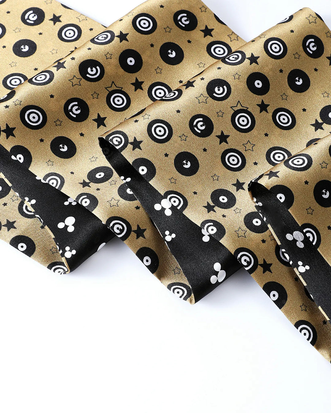 Gold fabric with black and white pattern on a white background