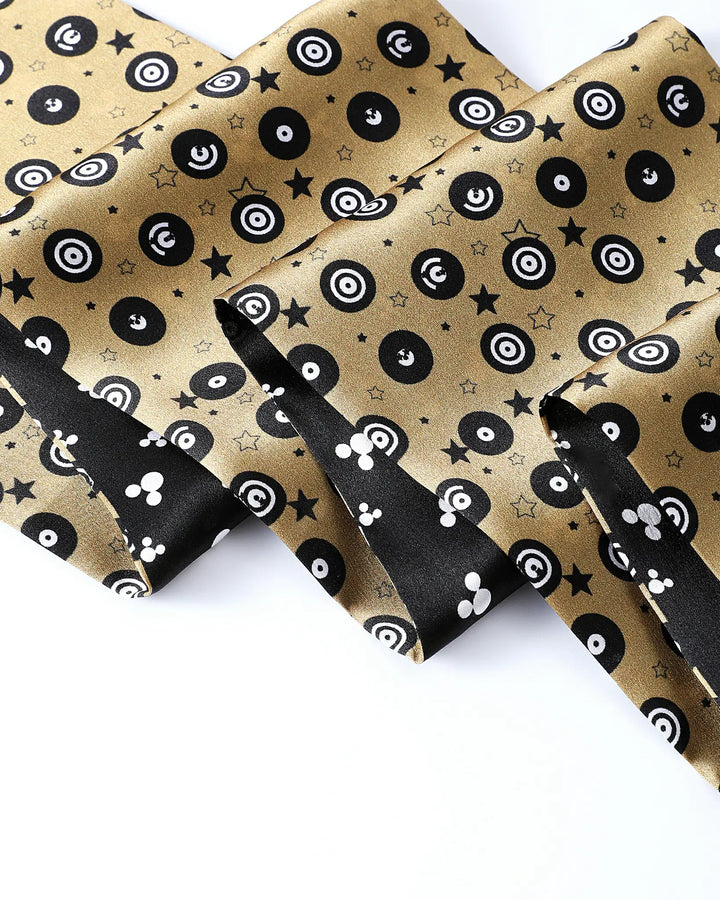 Gold fabric with black and white pattern on a white background