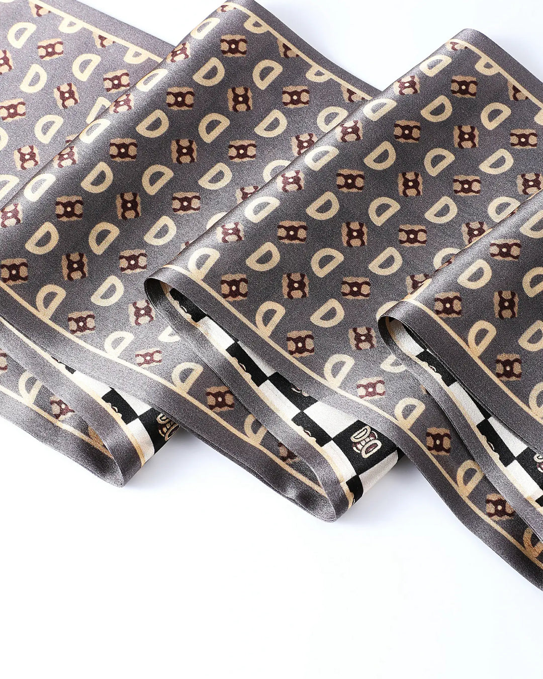 Folded gray necktie with brown and beige pattern on a white background