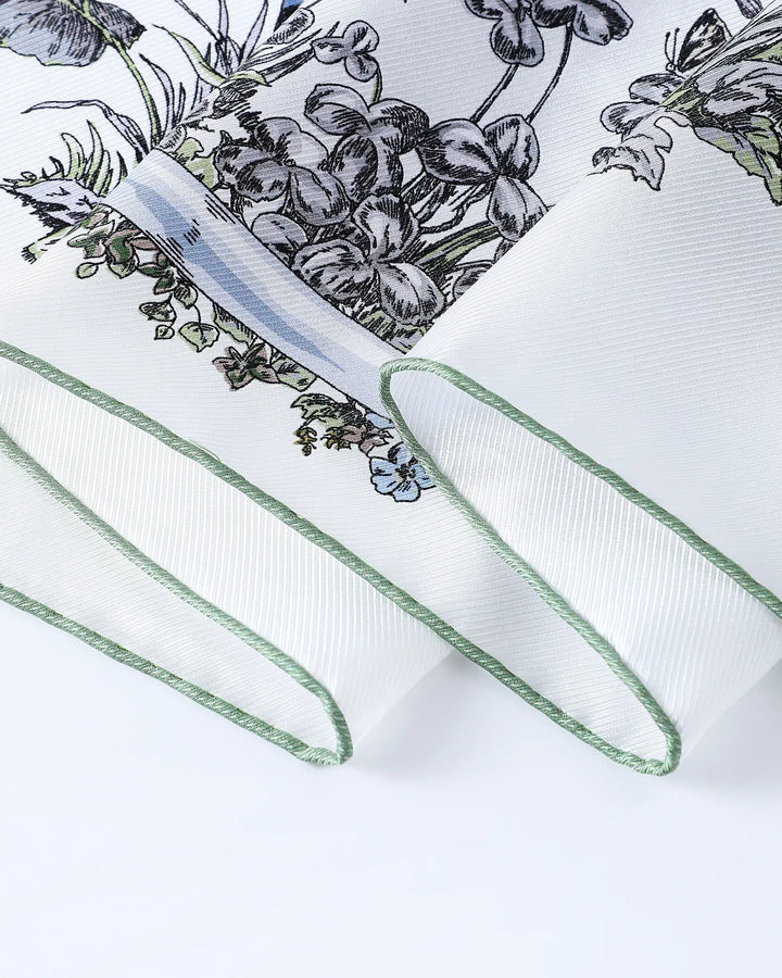 White ribbon with green edge on a white background with floral design