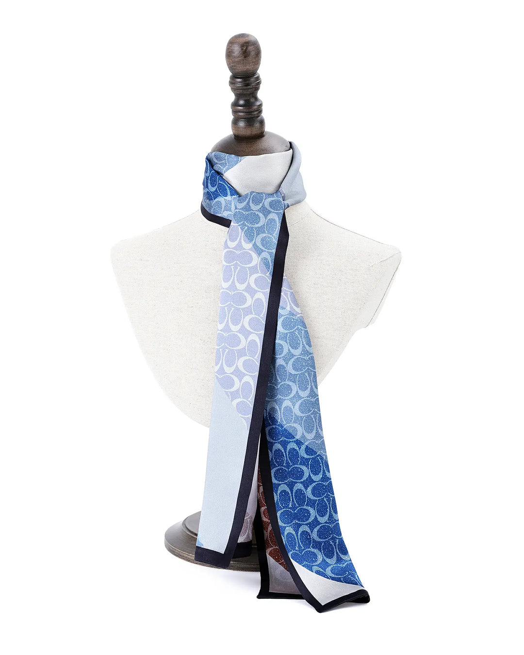 Scarf with blue and white pattern draped over a mannequin on a white background