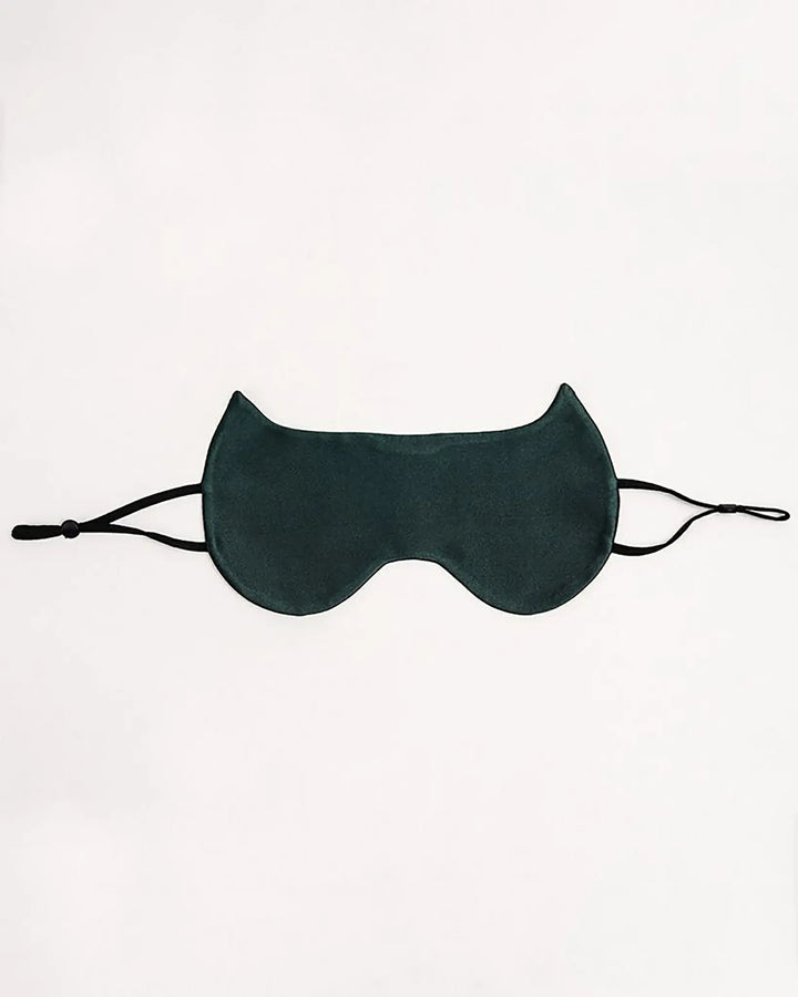 A dark green SusanSilk Cat Shape Silk Eye Mask with cat-ear-shaped design, featuring black adjustable straps on either side, is laid flat on a white background.