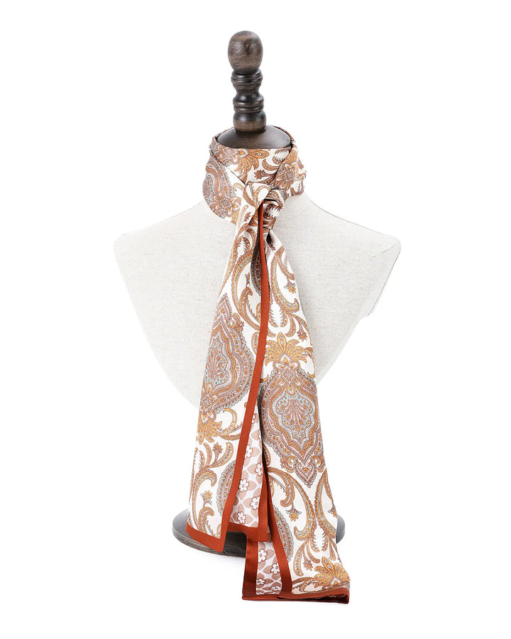 Patterned scarf draped over a mannequin bust on a white background