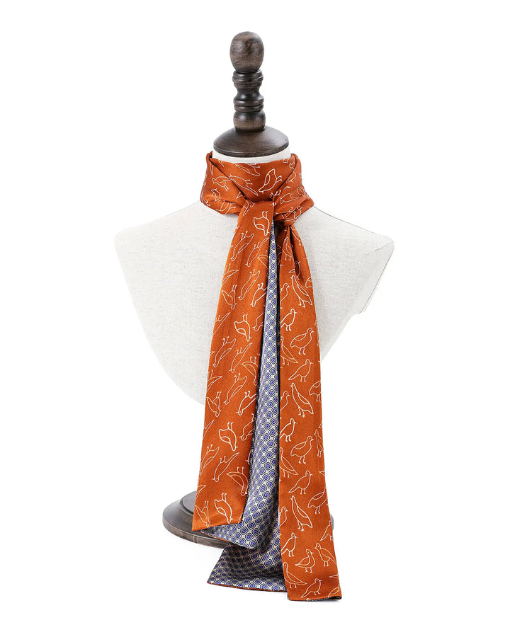 Mannequin wearing a patterned scarf on a white background