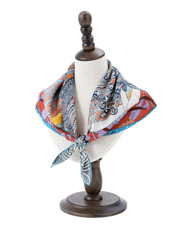 Colorful patterned scarf draped over a mannequin bust on a white background