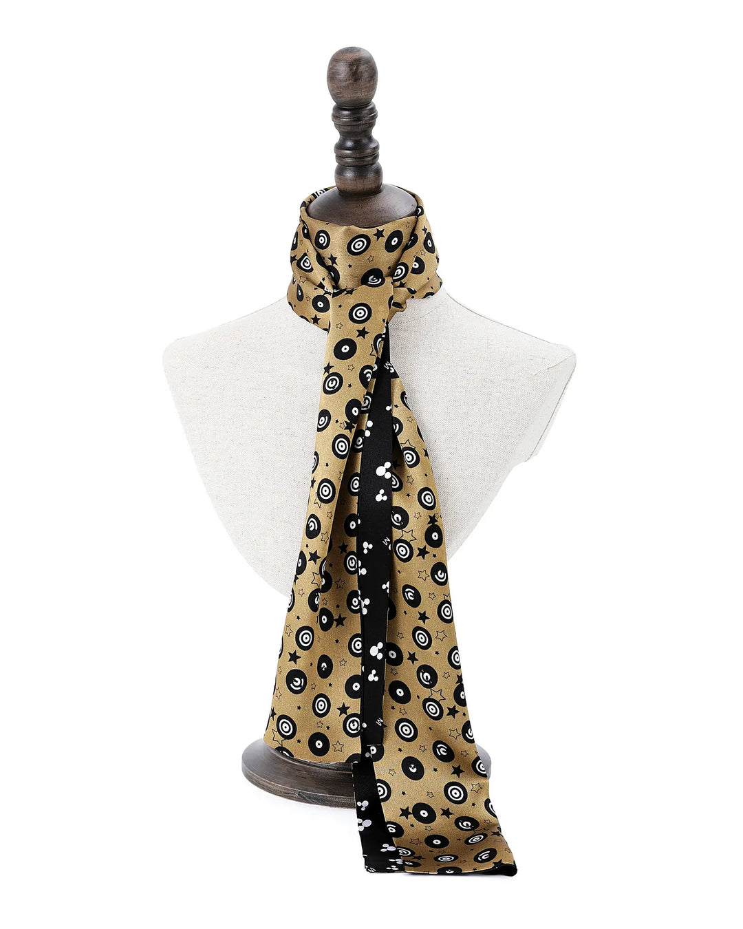 Scarf with black and white pattern draped over a mannequin on a white background