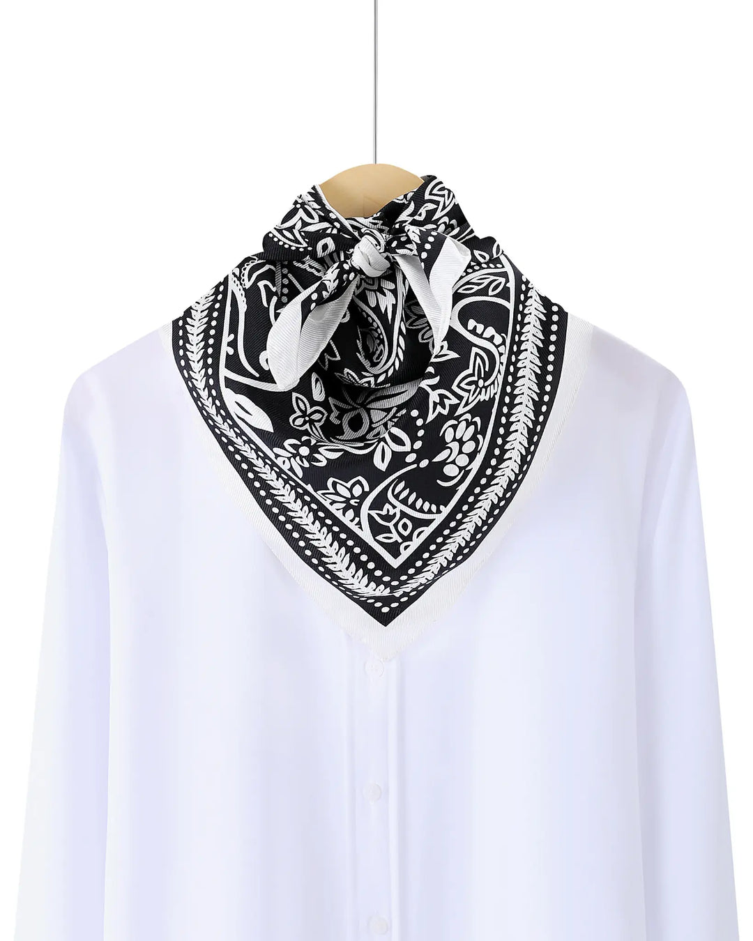 Black and white patterned bandana on a white shirt with a white background