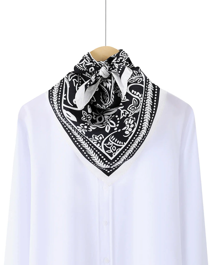 Black and white patterned bandana on a white shirt with a white background