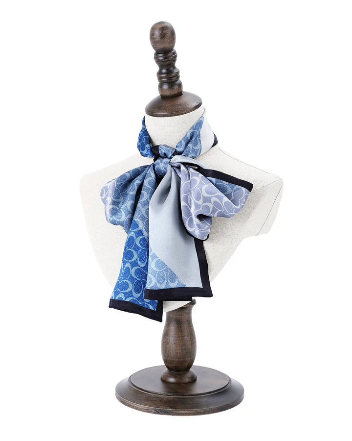 Mannequin torso with a blue patterned scarf on a white background