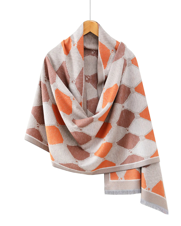 Geometric patterned scarf on a hanger against a white background