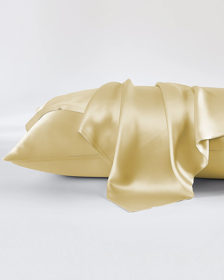 Gold satin pillowcase on a white background