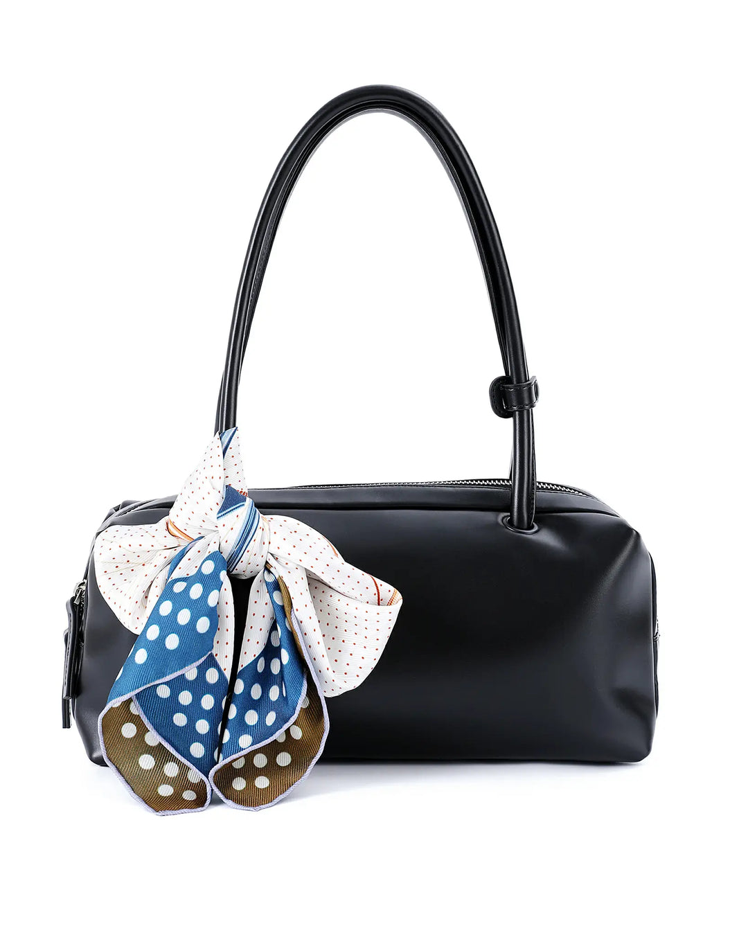 Black handbag with a blue and white polka dot scarf draped over it on a white background