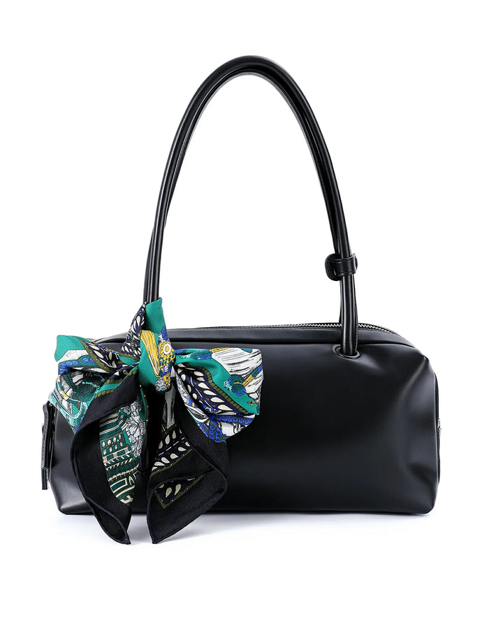 Black handbag with decorative bow on a white background