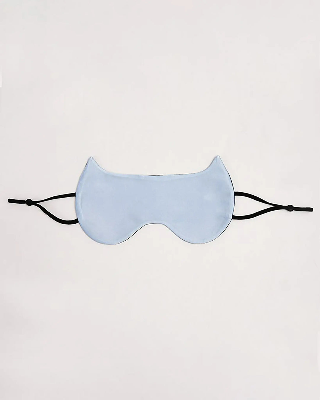 A SusanSilk Cat Shape Silk Eye Mask, featuring light blue silk and black elastic straps, is centered against a plain white background.