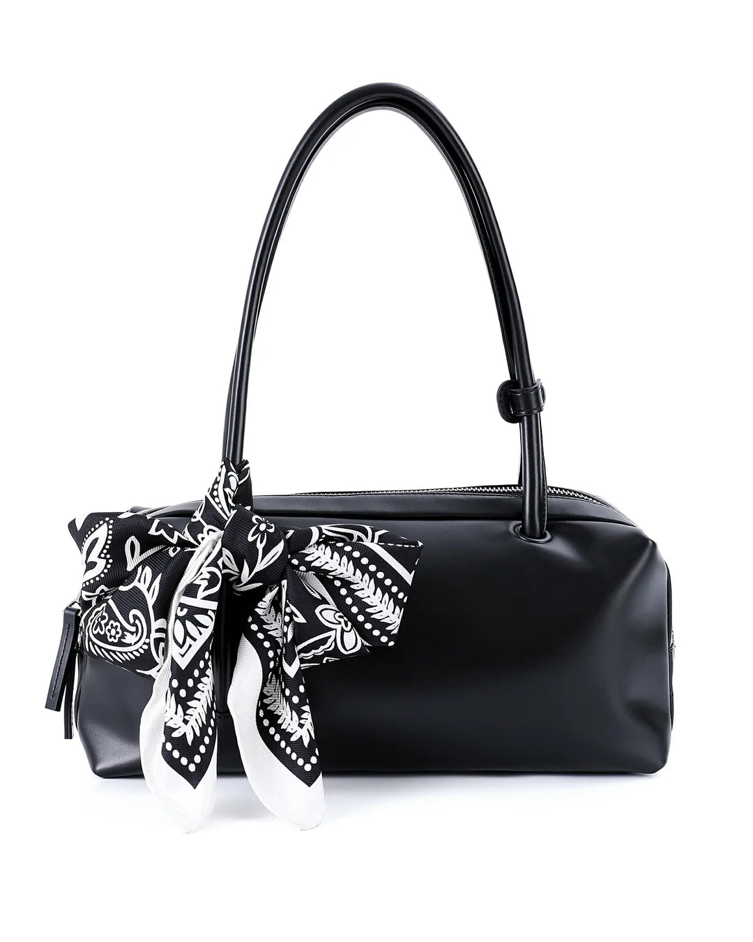 Black handbag with a black and white patterned scarf tied around it on a white background