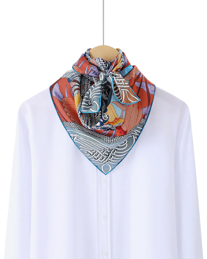 Colorful patterned scarf draped over a mannequin head on a white background