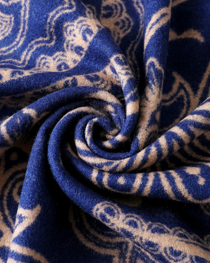 Close-up of blue fabric with beige paisley pattern