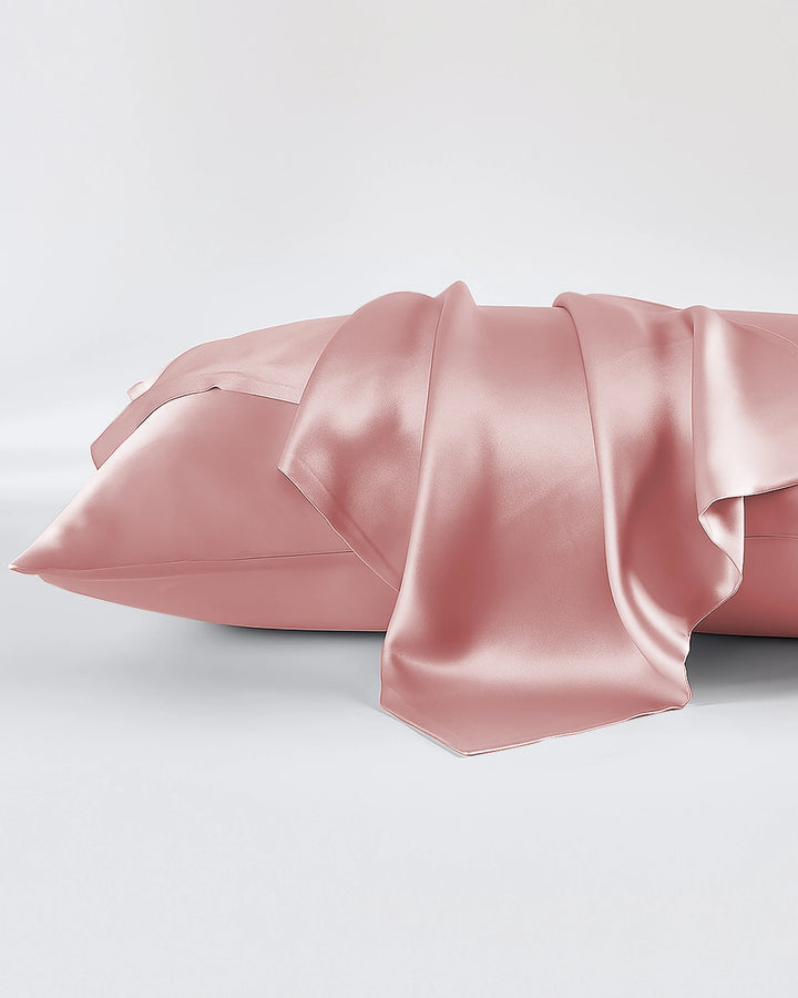 Pink satin pillowcase on a white background