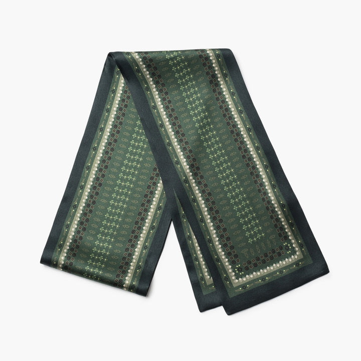 A long, dark green Daisy Silk Fluttering Belt from SusanSilk featuring intricate patterns and borders in lighter shades of green with small circular motifs.
