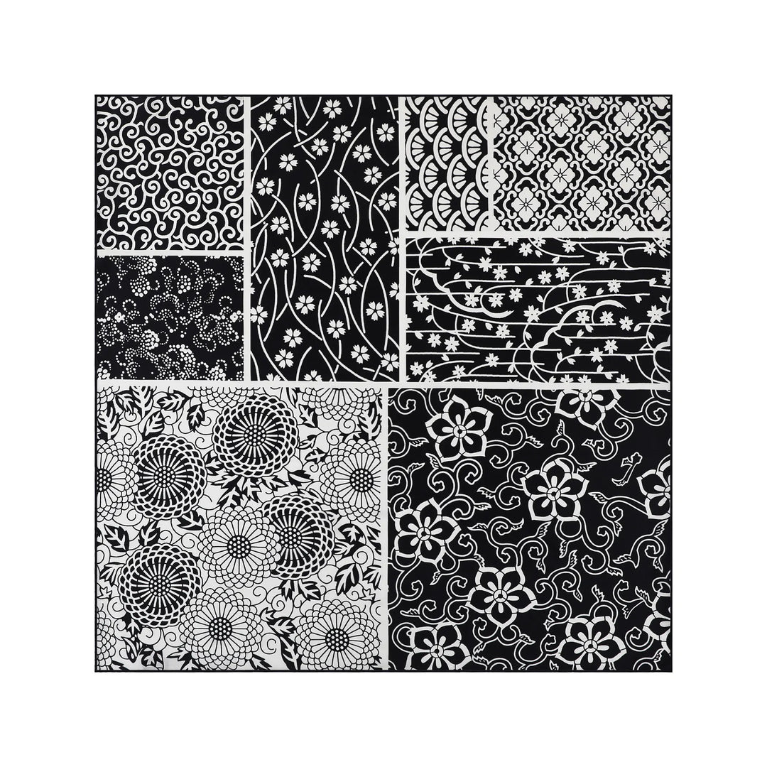 The Seeker Black Square Silk Scarf by SusanSilk features a black-and-white pattern collage, consisting of eight rectangular and square sections with intricate floral and geometric designs, reminiscent of delicate silk textures.