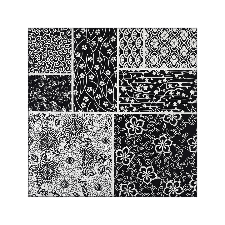 The Seeker Black Square Silk Scarf by SusanSilk features a black-and-white pattern collage, consisting of eight rectangular and square sections with intricate floral and geometric designs, reminiscent of delicate silk textures.