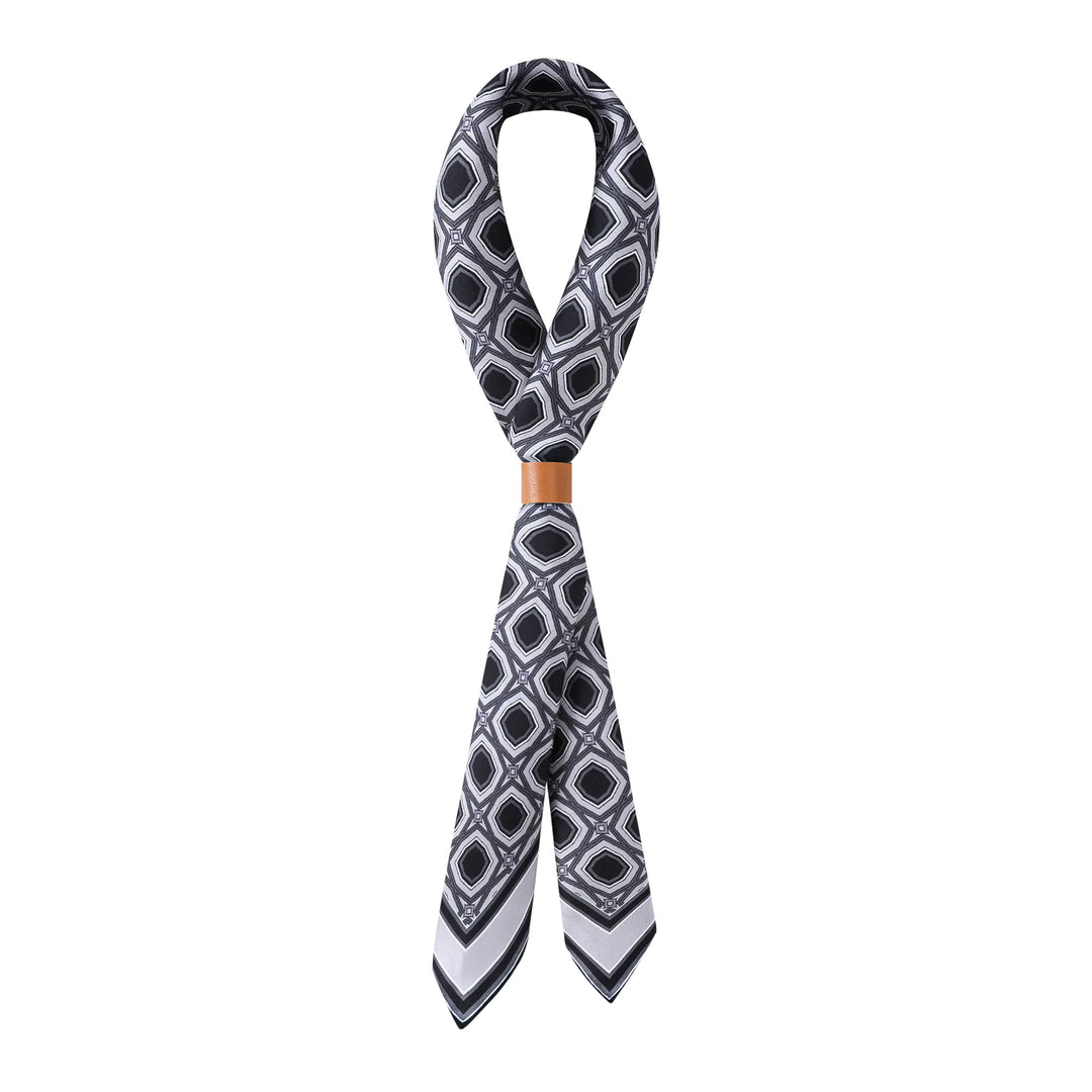A Sakuma Gray Square Silk Scarf by SusanSilk looped into a figure-eight shape with a tan leather band in the middle.