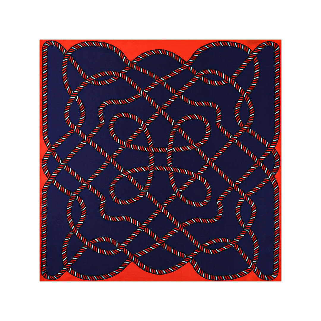 The Witch Hazel Orange Square Silk Scarf by SusanSilk features an intricate pattern of interconnected red, white, and blue silk ropes set against a dark blue background, all framed by a vibrant red border.