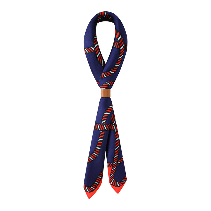 A Witch Hazel Orange Square Silk Scarf by SusanSilk, featuring a red, white, and green stripe pattern, is looped into a knot with the ends hanging down in a V-shape.