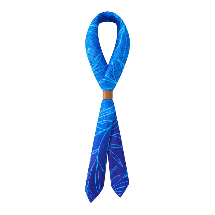 A Blue Sky Square Silk Scarf and a brown ring holder from SusanSilk, displayed against a white background.