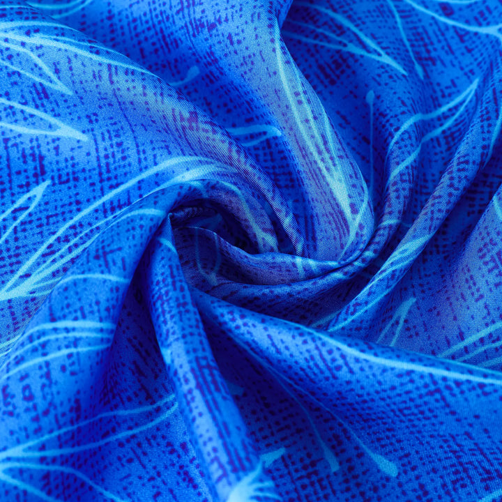 Close-up of the Blue Sky Square Silk Scarf by SusanSilk, showcasing a swirling pattern with light blue and white streaks against a grid-like texture.