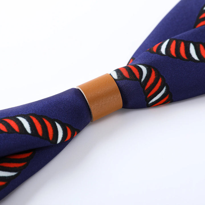 Close-up of the Witch Hazel Orange Square Silk Scarf by SusanSilk, showcasing intricate navy blue fabric adorned with twisted stripes in red, white, and black hues, elegantly held together by a brown leather band.