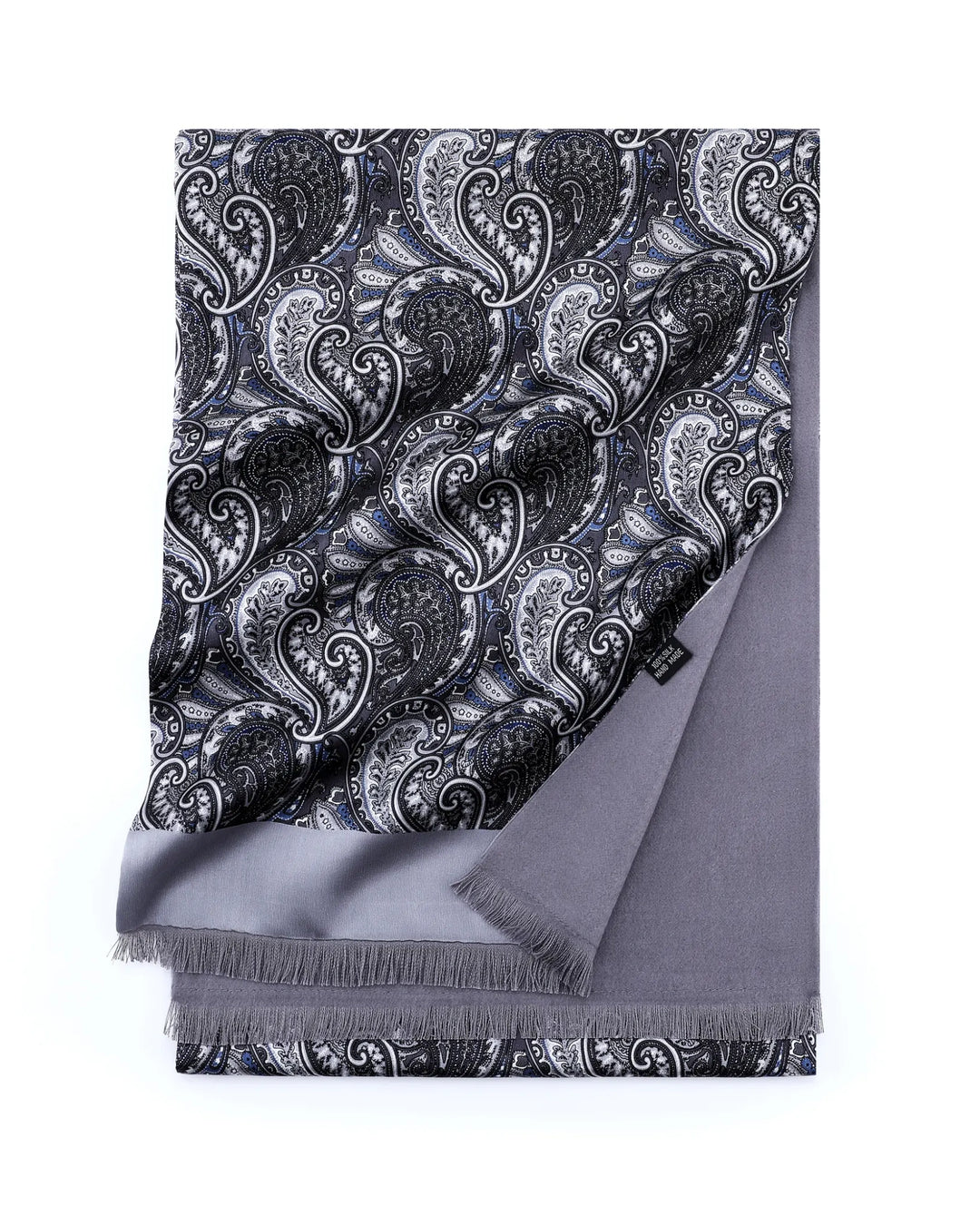 A folded gray scarf with a black and white paisley pattern on one side and solid gray fringe on the other, displayed on a clean white background.#color_silver