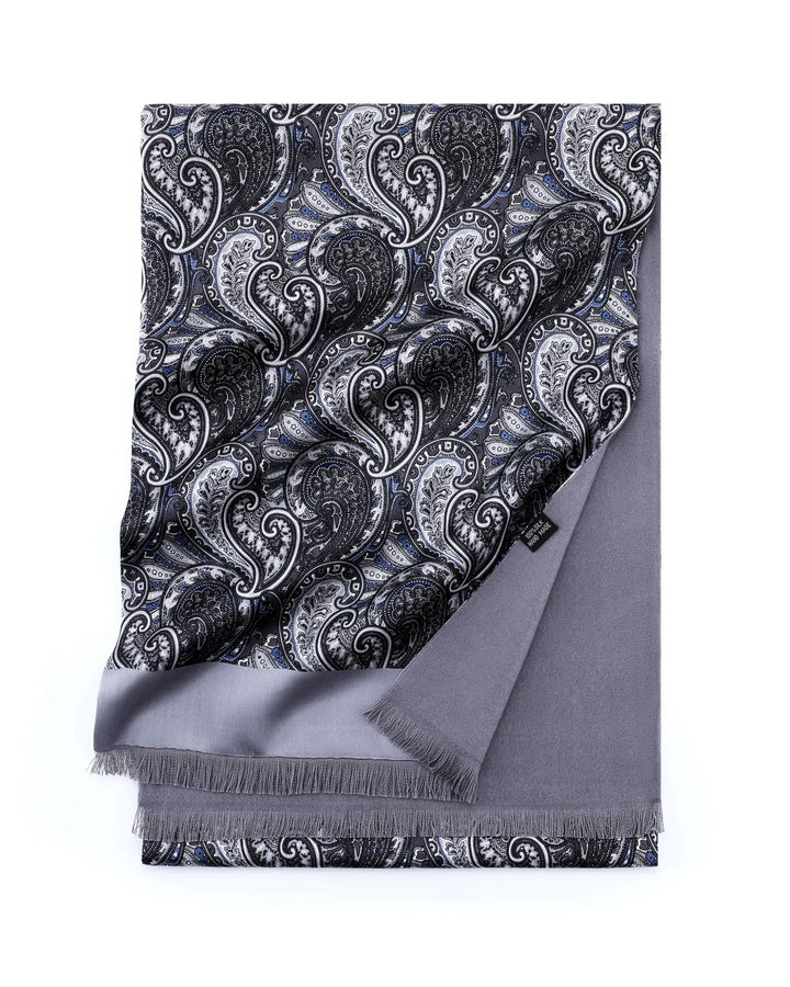 A folded gray scarf with a black and white paisley pattern on one side and solid gray fringe on the other, displayed on a clean white background.#color_silver